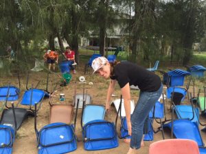 USA Youth cleaning chairs ready for packing. From her back yard to schools in need.