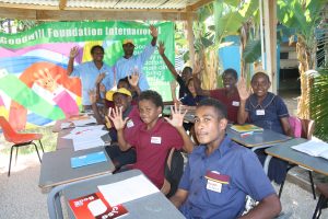 Donated desks and chairs in use in temporary outdoor class room. New container classroom on its way to completion. 