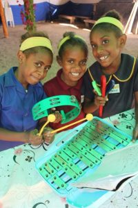 Donated musical instruments bring joy to young faces.